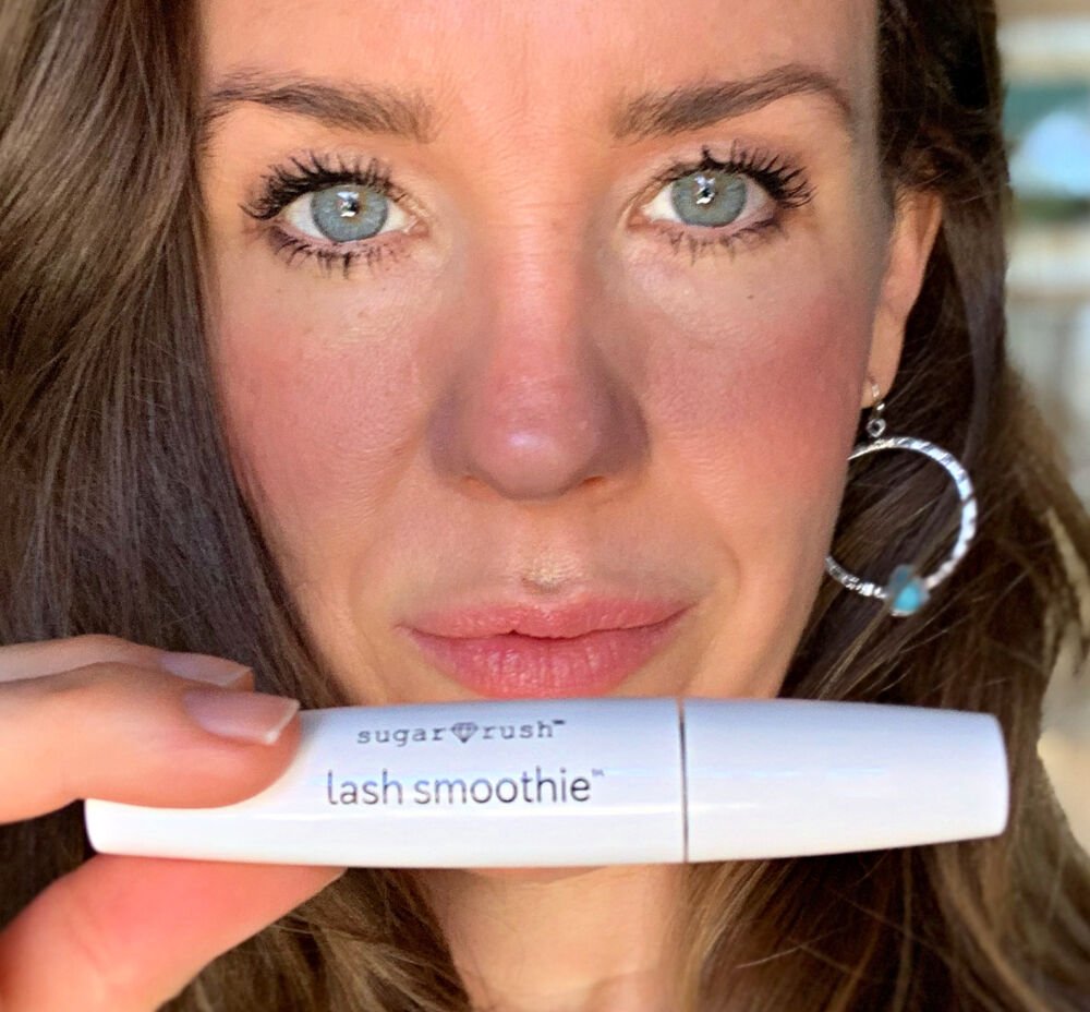 Woman holding Lash Smoothie mascara tube