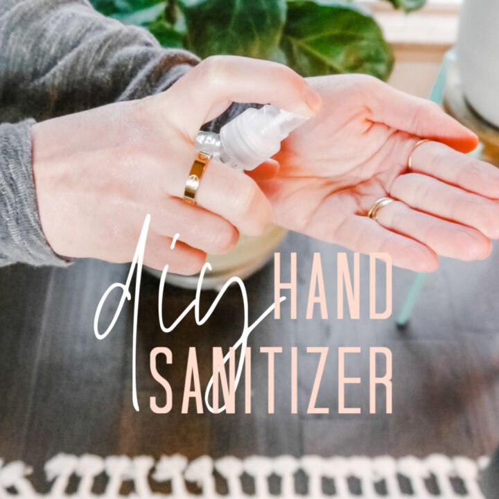 Hand spraying sanitizer in the other hand
