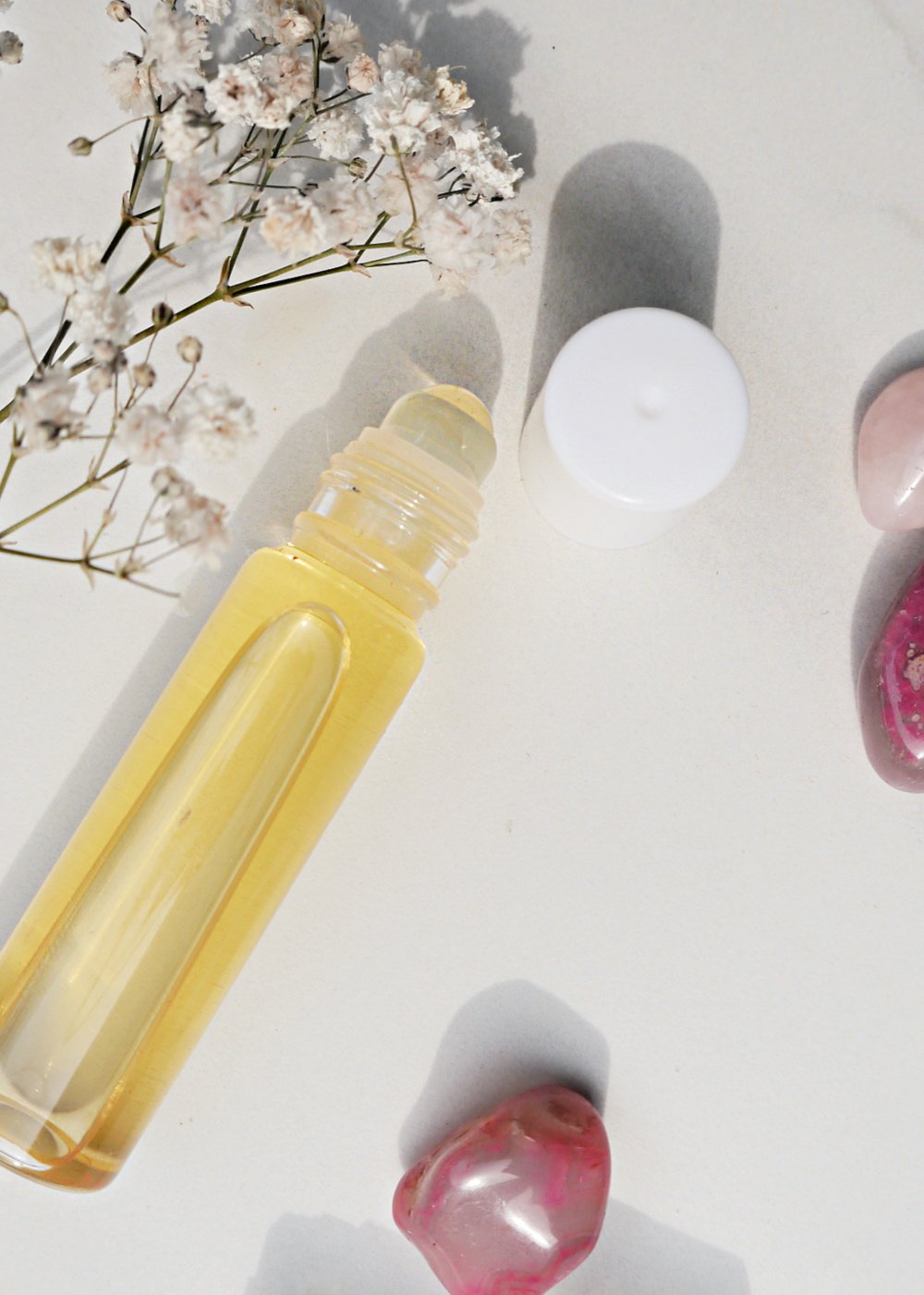 Roller Bottle with lip oil and babies breath and pink stones