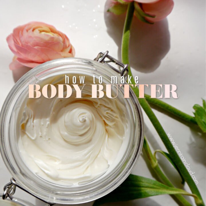 A flip top jar with diy body butter and 2 peach flowers around the jar.