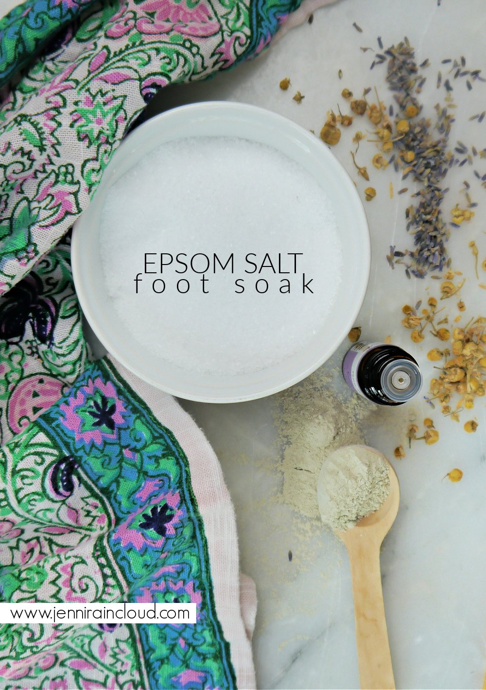 Colorful napkin with a white bowl with salt, a wooden spoon with clay and a bottle of essential oils. 