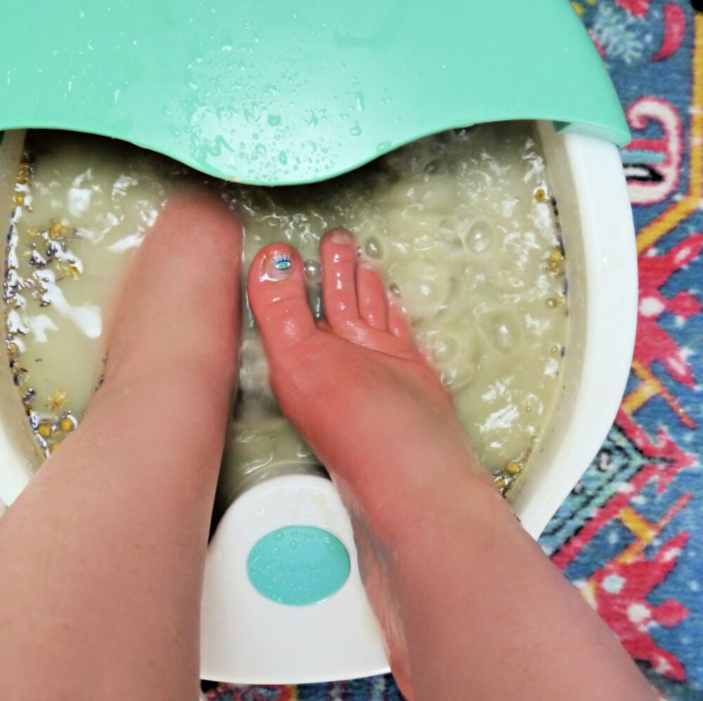 Feet in a foot spa with the Epsom Salt foot soak