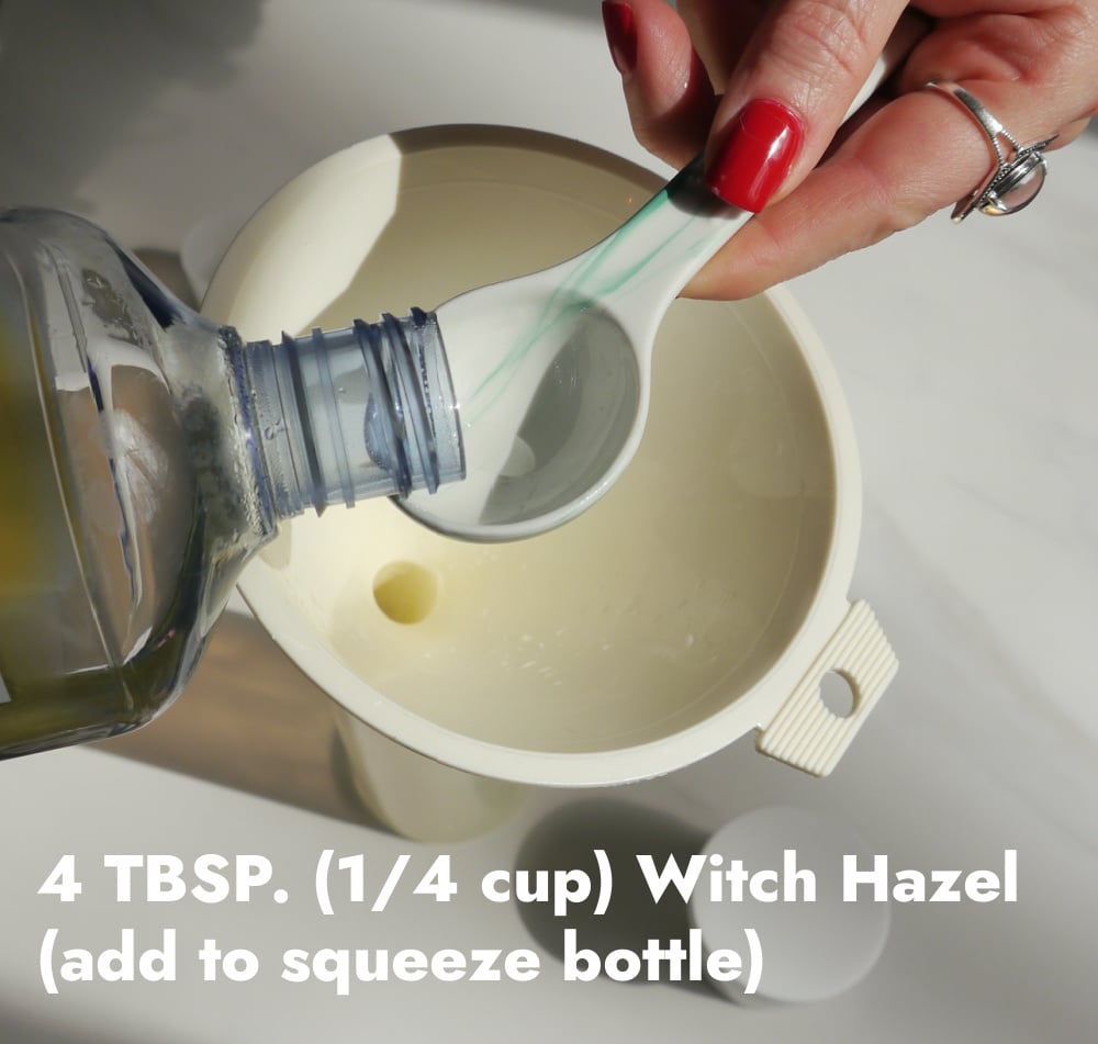 Hand pouring witch hazel into a white funnel.