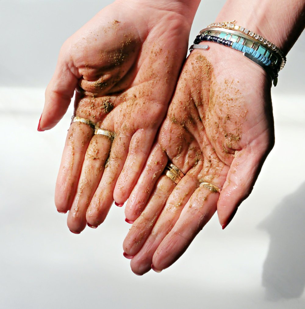 2 hands showing exfoliant wet on the palms.