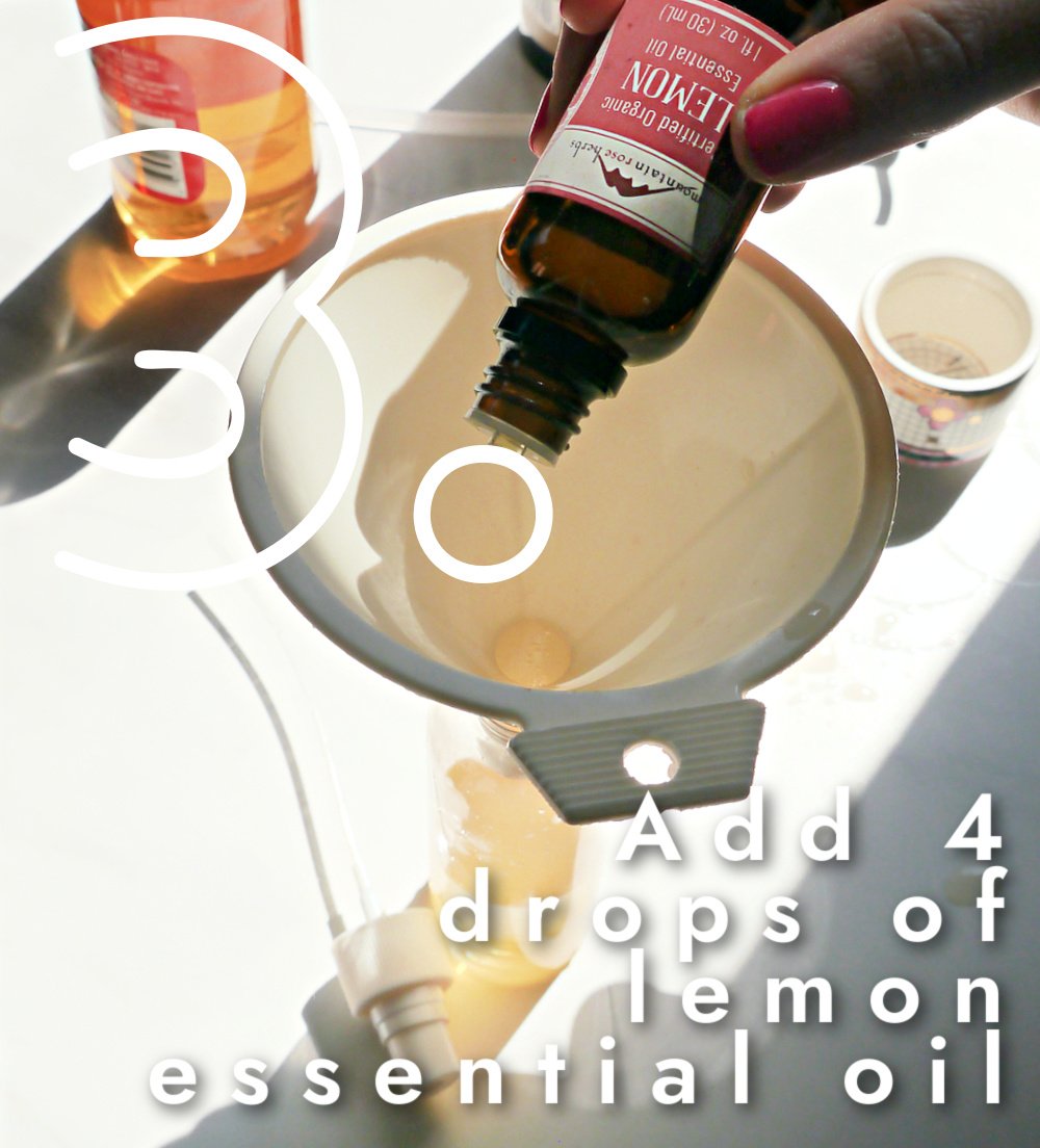 Dropping lemon essential oil into a funnel.